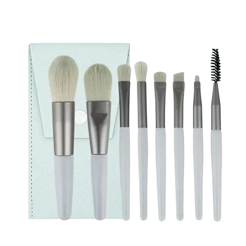 Set of seven professional makeup brushes with soft white bristles and silver white handles beside a light blue case