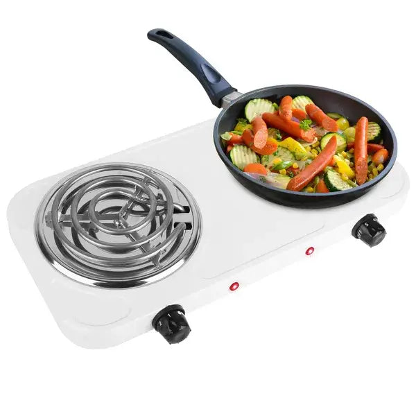 White electric double burner 2000w portable hot plate stove with two coil burners black control knobs and a frying pan filled with colorful vegetables.