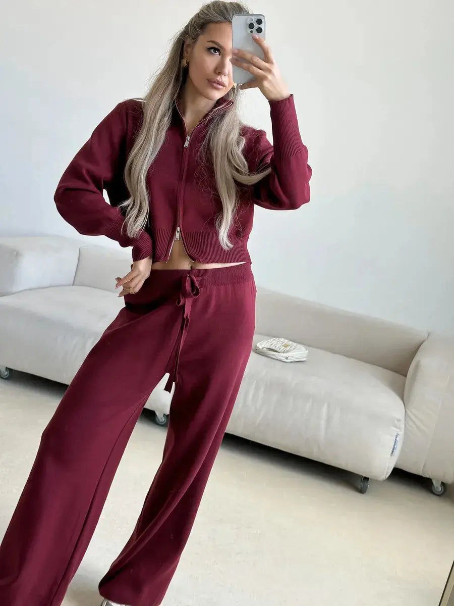 Maroon velour women’s knit zip up cardigan and wide leg pant set featuring a zipper front and drawstring waistband.