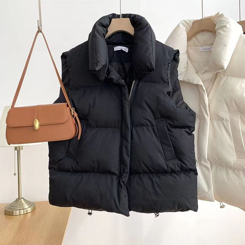 Black quilted puffer vest for women featuring a loose fit, high collar, sleeveless design, and front zipper for comfortable outerwear.