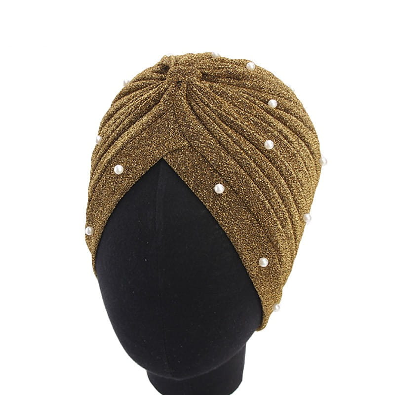 Gold glitter turban headscarf cap for women adorned with white pearls made of shimmering jacquard fabric.