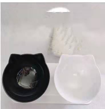 Elevated cat bowl tilted 15 degree double feeder stand with black and white cat-shaped glossy plastic pet bowls designed for comfortable feeding.