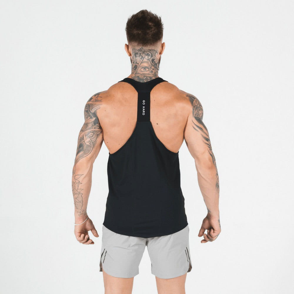 Back side of a black men’s racerback athletic tank top featuring go hard text on the strap, designed for high performance workouts.