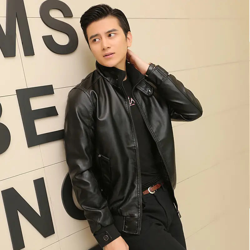 Men’s black faux leather bomber jacket with a sleek glossy finish and classic zipper closure featuring a stand collar.