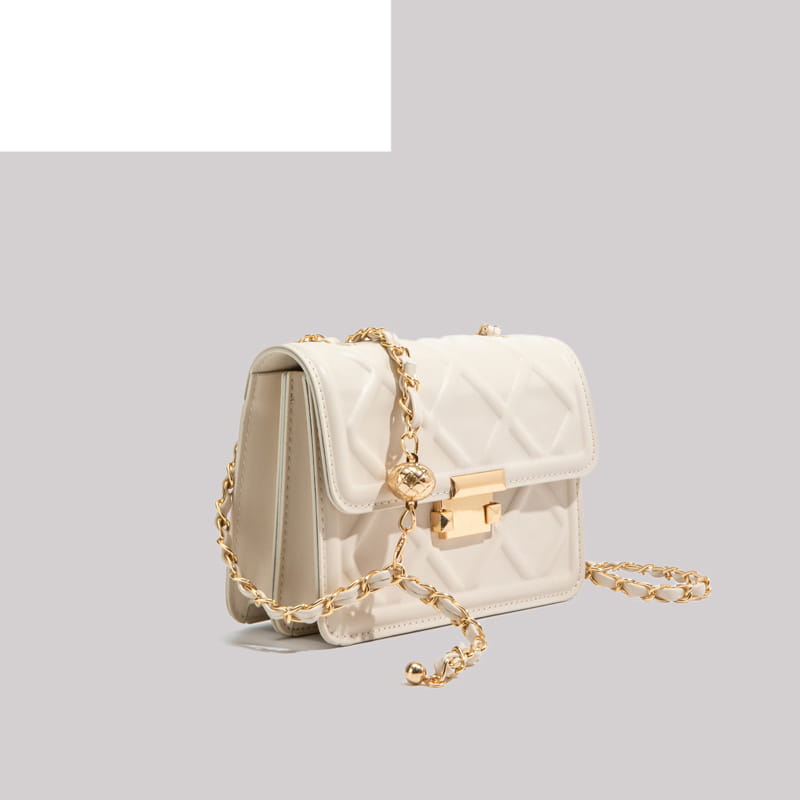 Cream-colored quilted crossbody bag with gold-tone chain strap and clasp displayed front side.