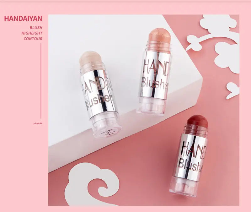 silver-tipped cylindrical cream blush sticks with clear plastic bodies and black lettering in peachy and deep red shades for long lasting face highlighting in eight colors