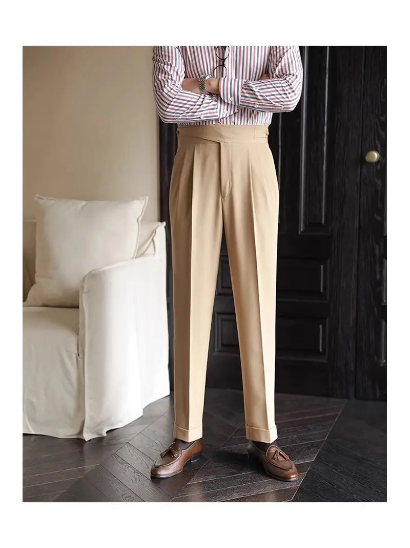 Beige tailored pleated wool trousers with a straight leg fit and rolled cuffs for men.