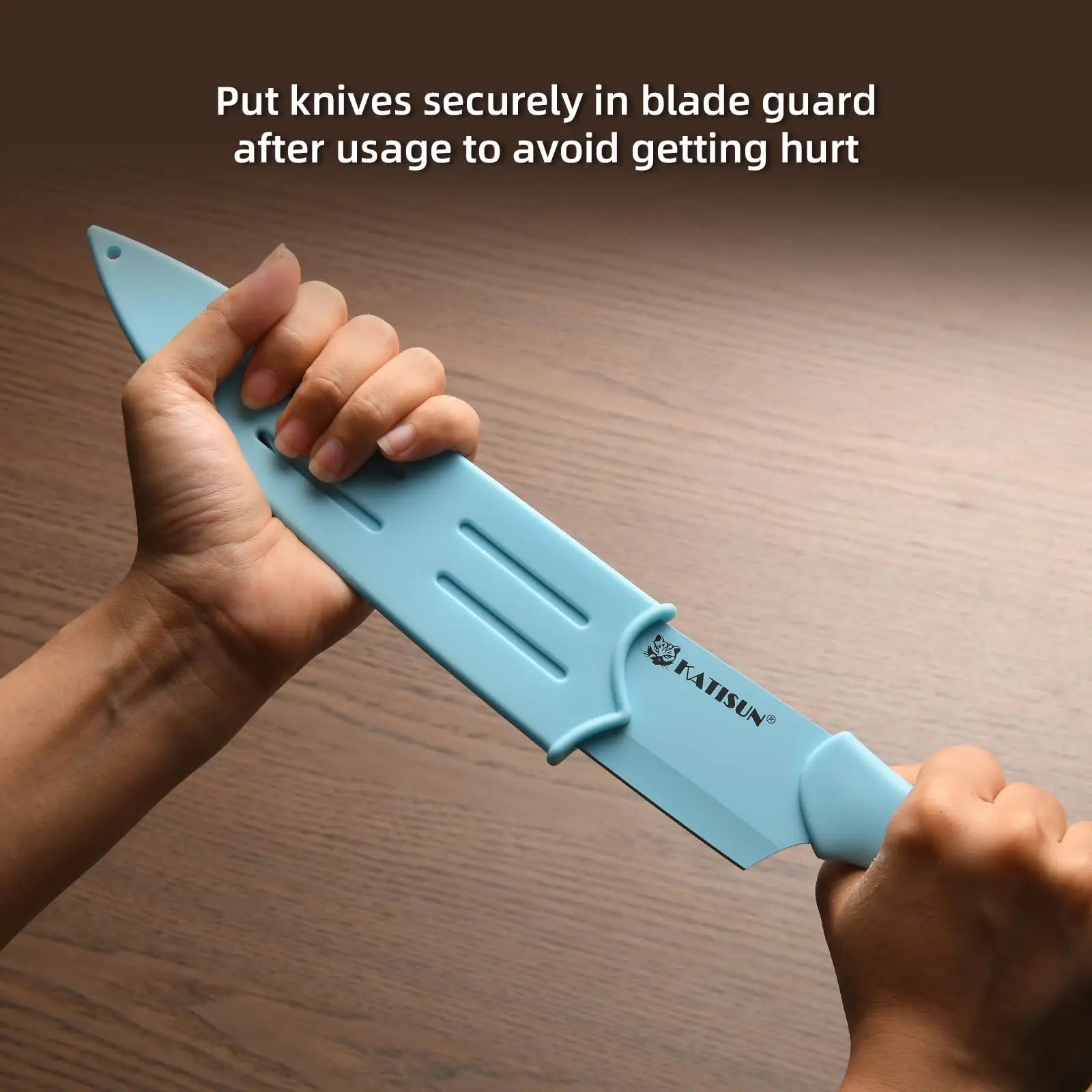 Light blue plastic blade guard with molded handle and horizontal slots for secure knife storage in 14 piece blue stainless steel knife set with block