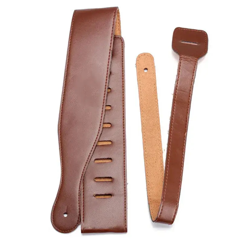 Brown leather guitar strap with adjustable holes and matching buckle featuring suede lining and adjustable length from 110 to 130 centimeters.