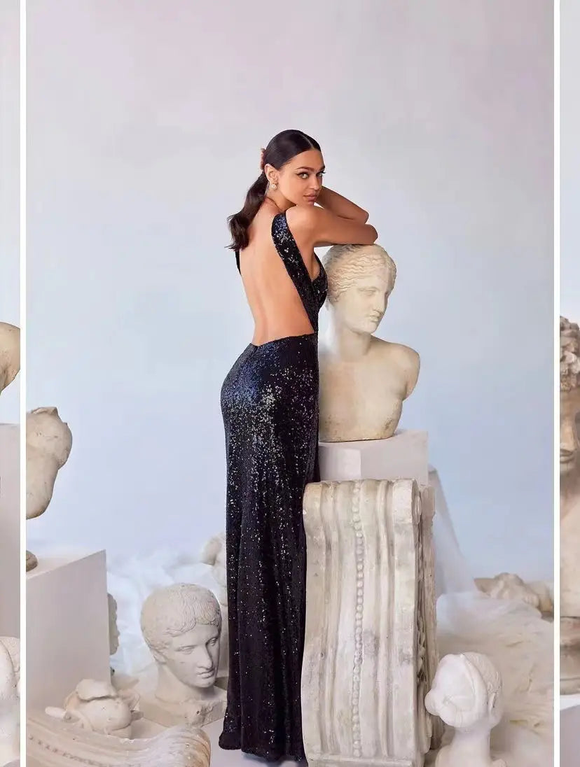 a shimmering black sequined halter neck evening gown with a plunging back and high slit shown from the back side