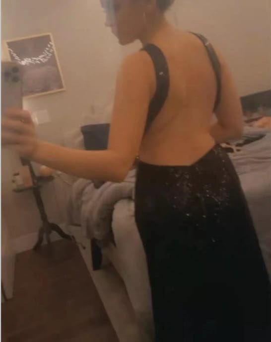 black sequined halter neck evening gown with thin straps backless design and high slit shown from the back