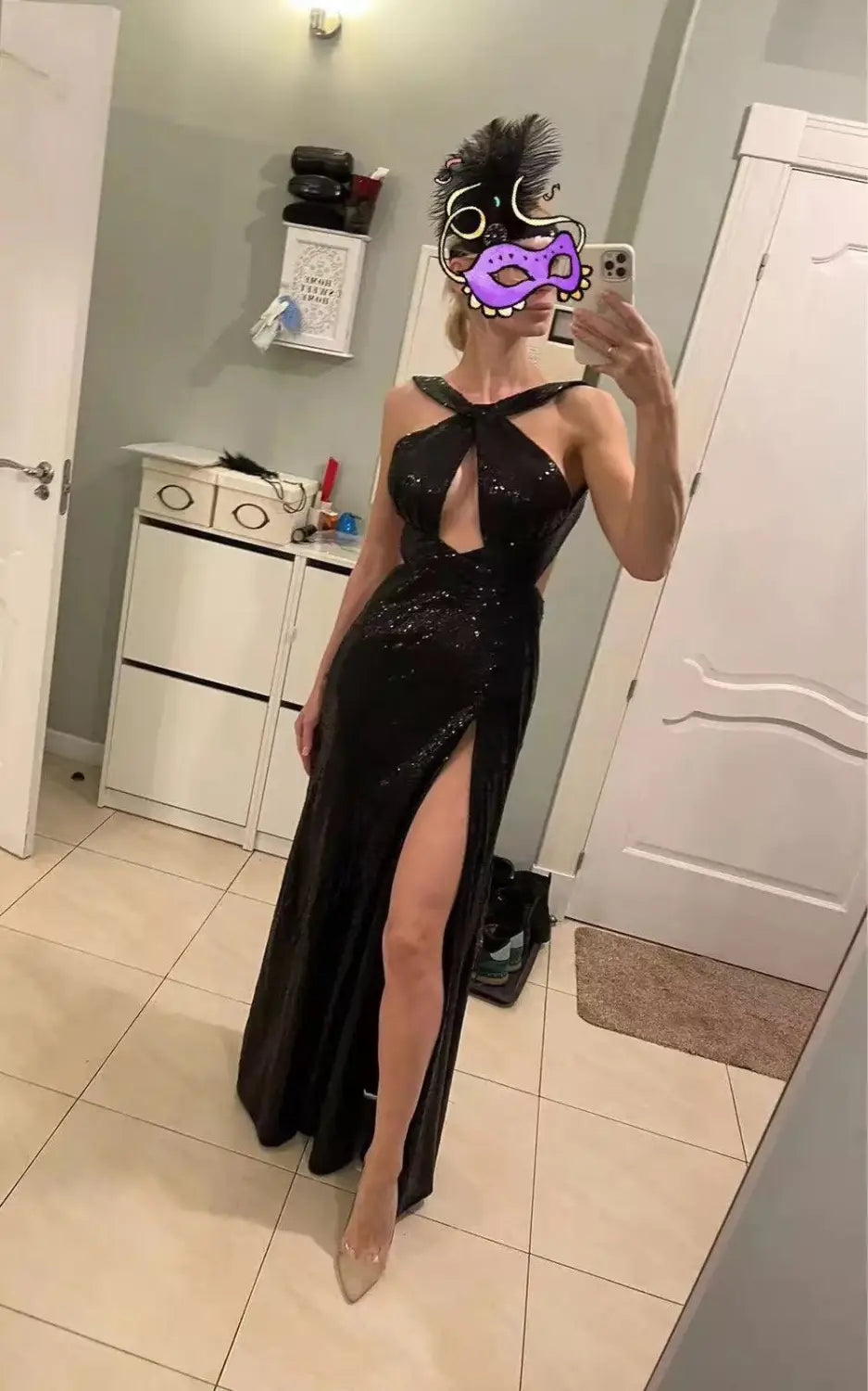 a black sequined halter neck evening gown with a high slit designed for formal occasions