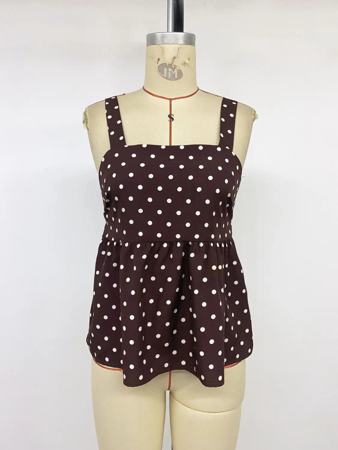 Brown polka dot peplum camisole featuring white dots and thin straps suitable for casual wear