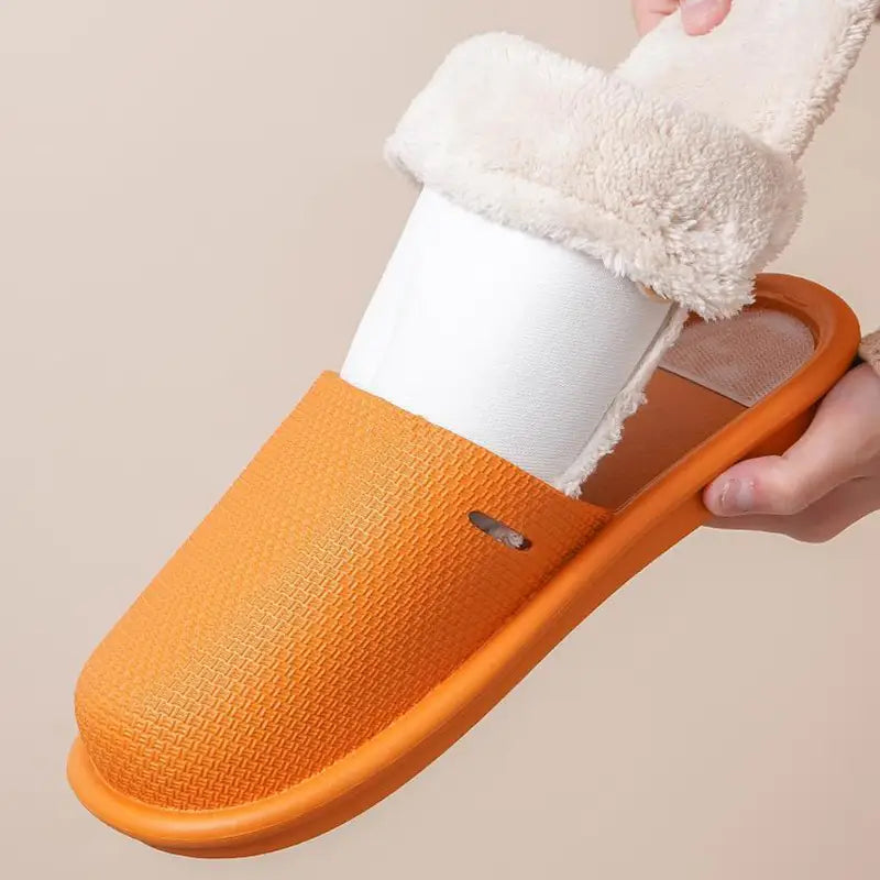 Orange textured slip-on slide winter slippers for women with washable plush white fleece lining for indoor use.