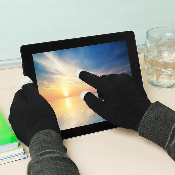 Black knit winter touchscreen gloves with white fingertips designed for warm texting and tablet use.