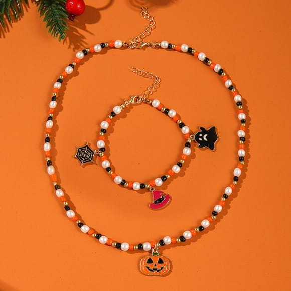 Halloween ghost and pumpkin beaded jewelry set featuring an orange and black beaded necklace with dangling pumpkin witch hat spiderweb and ghost charms.