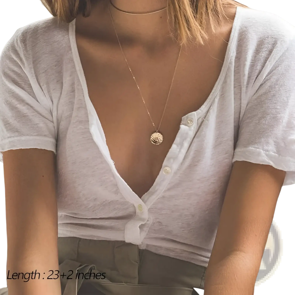 A 14k gold plated layered necklace set featuring a gold-toned delicate circular pendant with intricate details