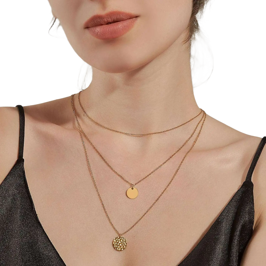 14k gold plated triple layered coin and bar necklace with gold toned delicate chains and two circular pendants against skin