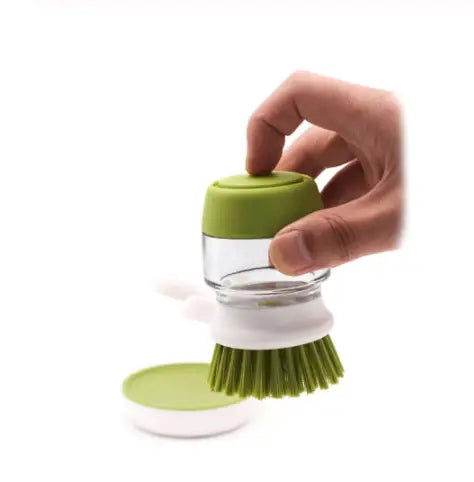 Soap dispensing dish brush with green bristles, clear glass container, and lime green lid designed for easy soap storage and non slip storage base.