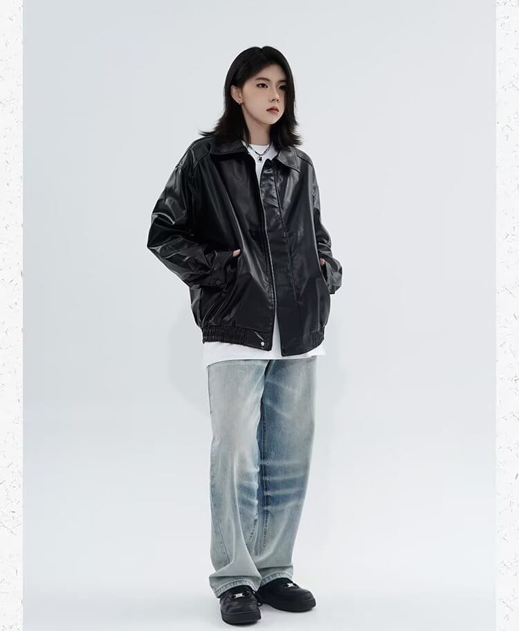 Men’s black glossy faux leather bomber jacket with a relaxed fit designed for outerwear.