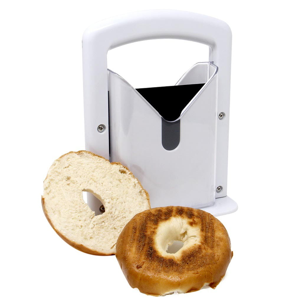 White plastic and stainless steel bagel slicer guillotine with safety guard and handle designed for cleanly cutting bagels.