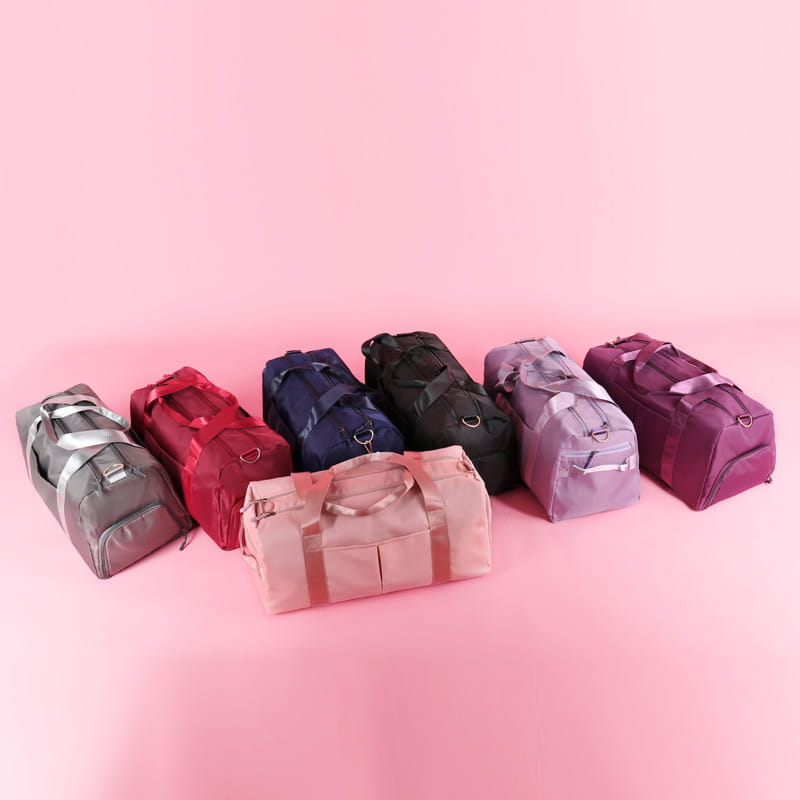 A collection of six waterproof Oxford travel duffel bags for gym and sports in gray red navy blue black lavender and maroon colors.