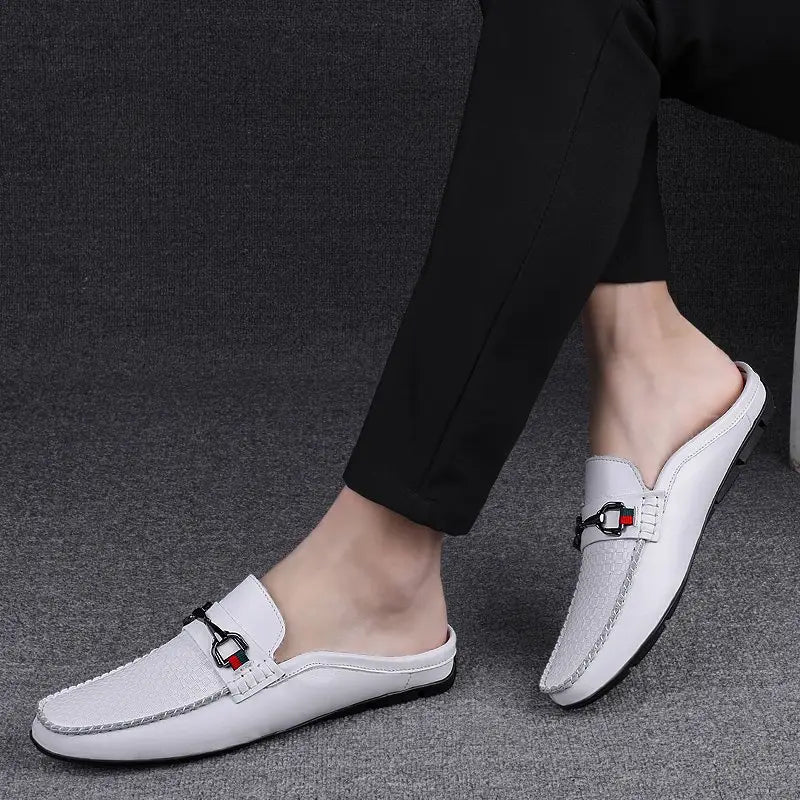 Men’s white leather moccasin loafers with black and red woven buckle accent.
