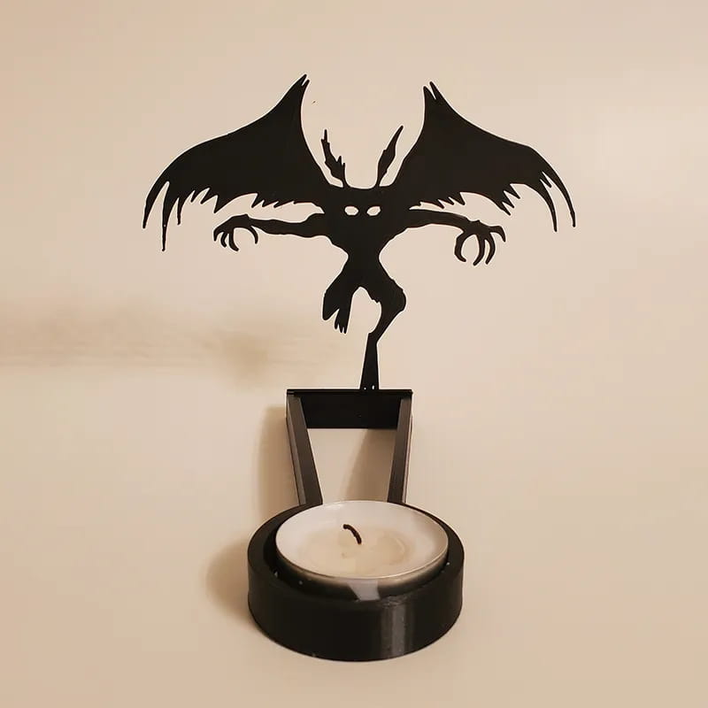 Black metal bat-shaped candle holder with a sleek minimalist design for Halloween shadow decor.