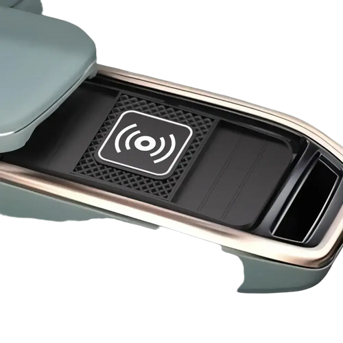 A sleek matte black 15w fast wireless charging pad with textured surface and white icon in a car center console