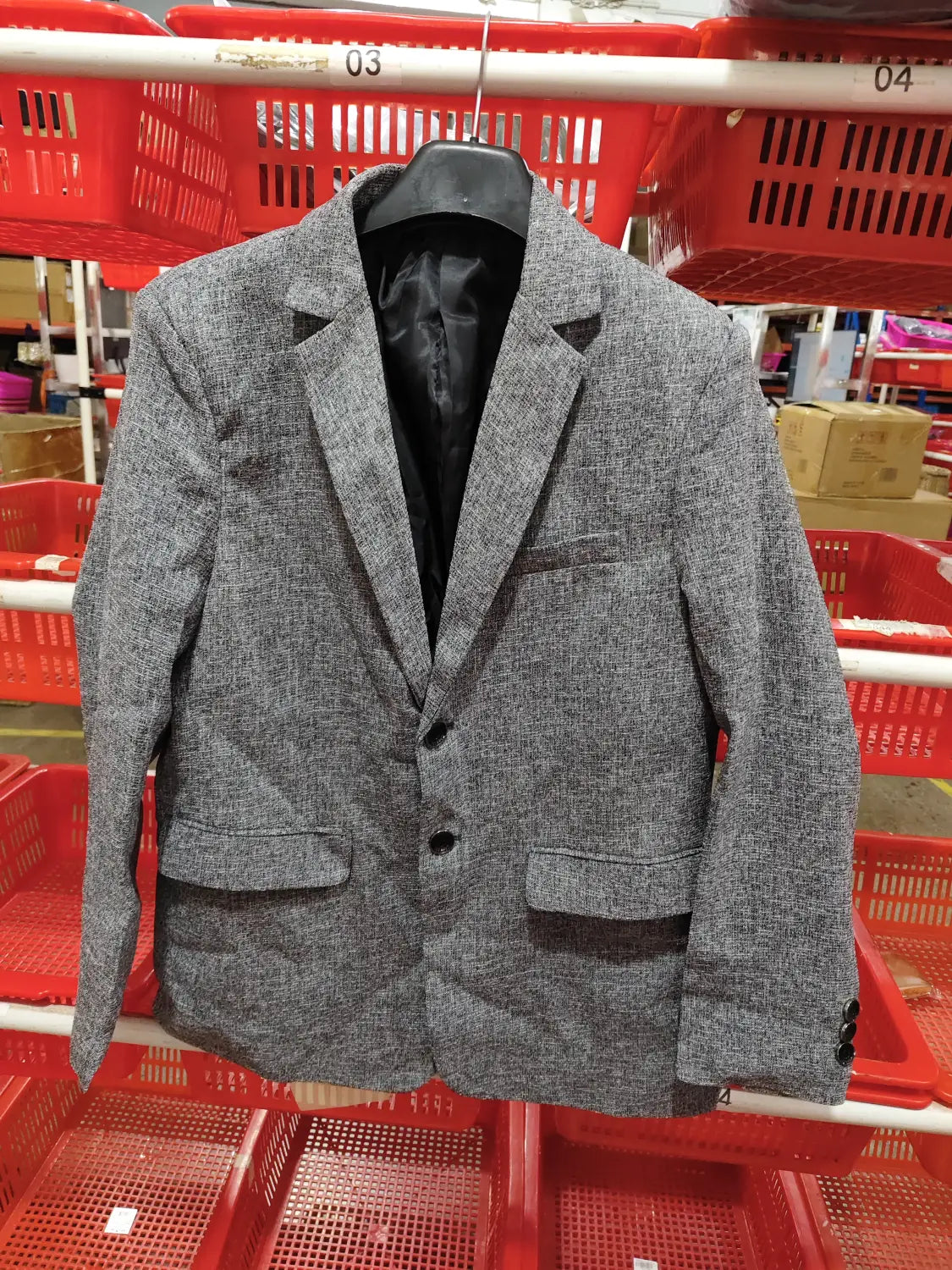 Men’s casual thin blazer spring jacket in gray textured fabric with black inner lining and three-button front.