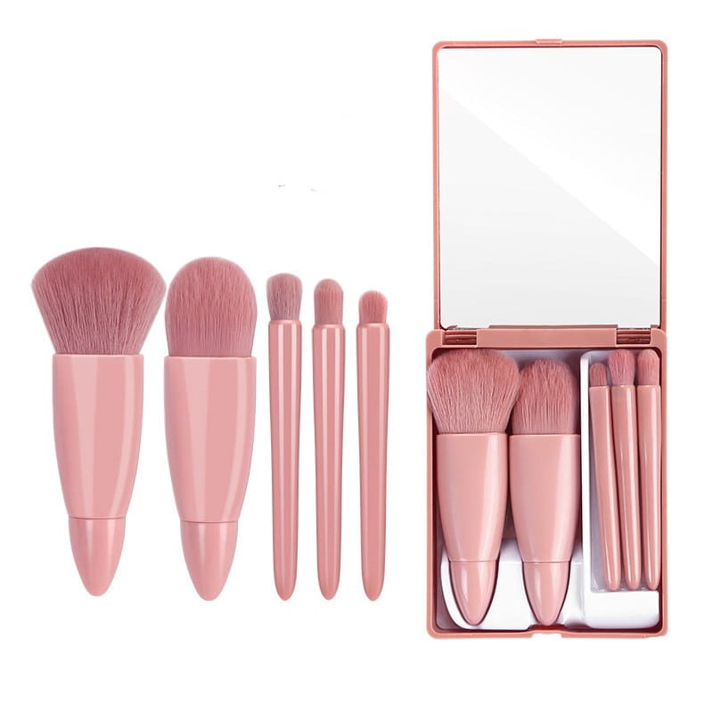 pink makeup brush set with five pieces and matching rose gold compact mirror designed for portable use