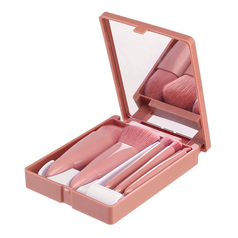 Pink plastic five piece makeup brush set with matching mirror in a compact portable case