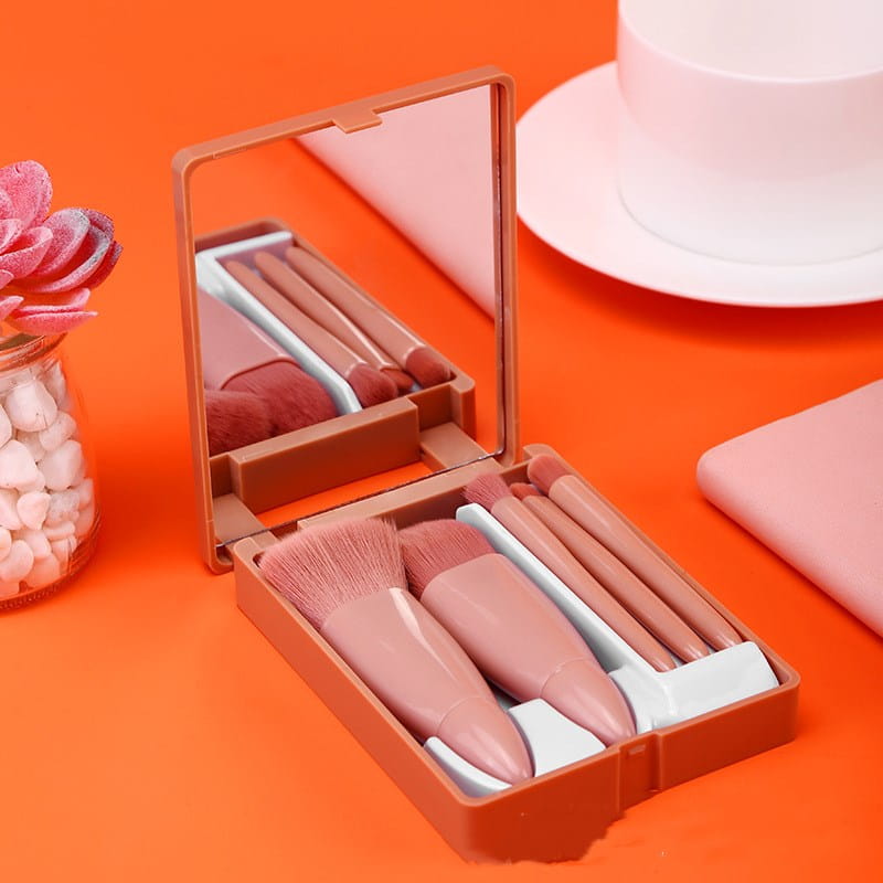 makeup brush set with mirror featuring five pink brushes in a compact portable case with an integrated mirror.
