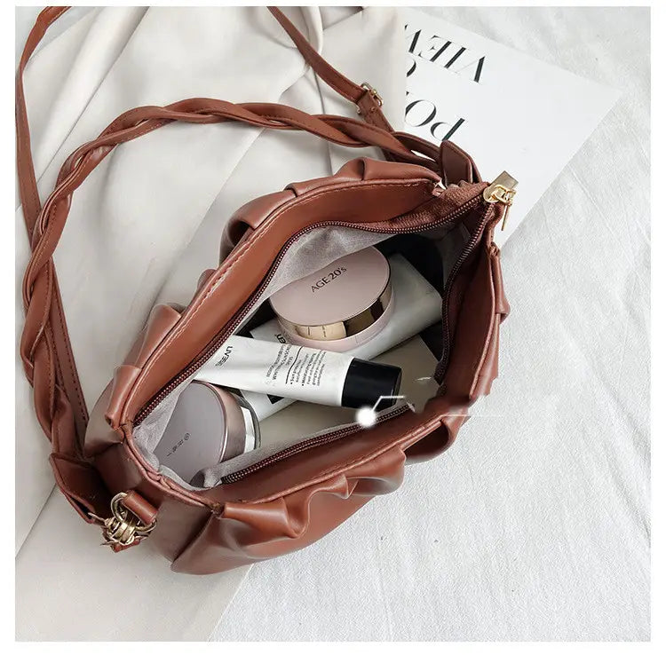 Brown pu leather pleated crossbody bag for women with braided strap and gold tone hardware.