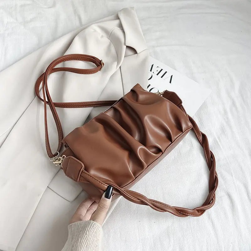 Brown pu leather pleated crossbody bag for women featuring a ruched design and braided strap.