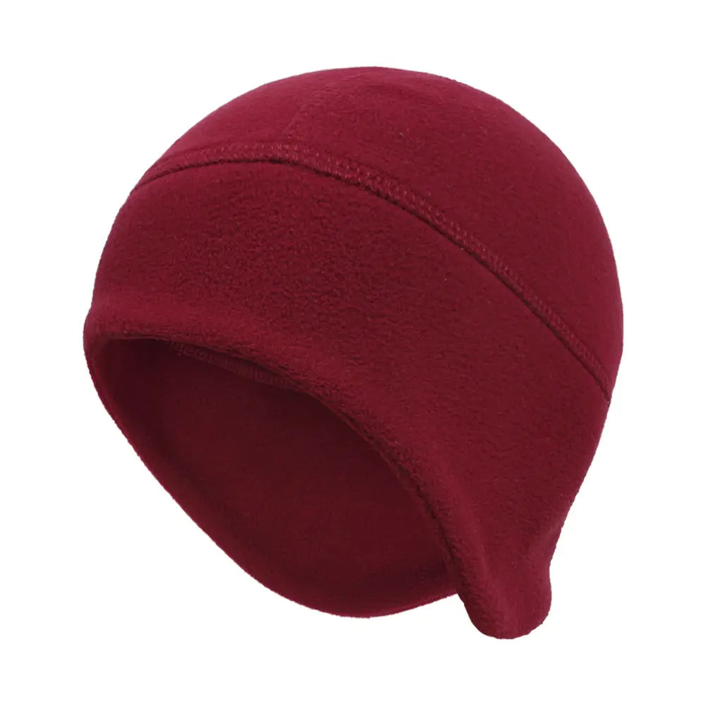 A soft solid maroon thermal fleece beanie hat made of windproof material designed for winter sports with a snug fit and subtle seam detailing.