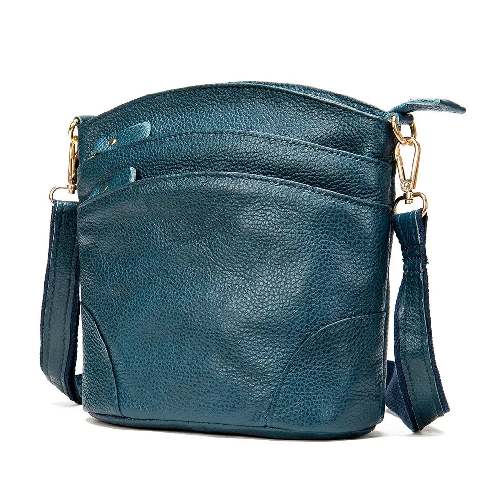 Teal pebbled leather crossbody bag with gold-tone hardware and adjustable strap designed as a retro cowhide shoulder purse.
