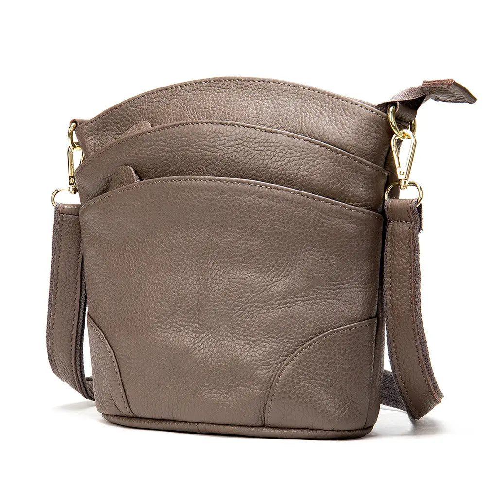 Brown textured leather crossbody bag with gold-tone hardware and adjustable strap featured as a retro cowhide shoulder purse.