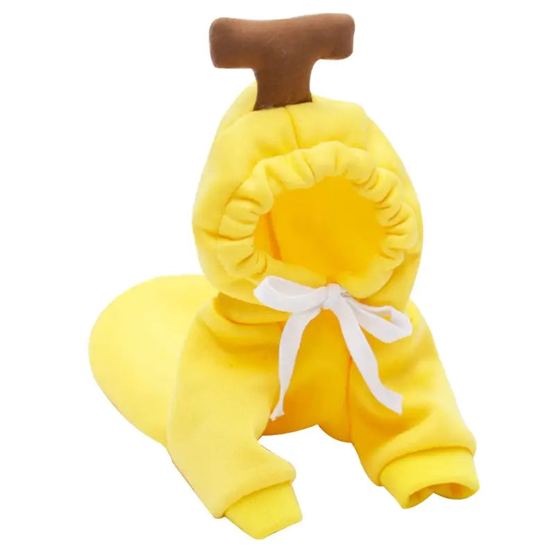 Bright yellow plush banana-themed pet hoodie with a brown stem and white bow at the neckline designed for winter clothes.
