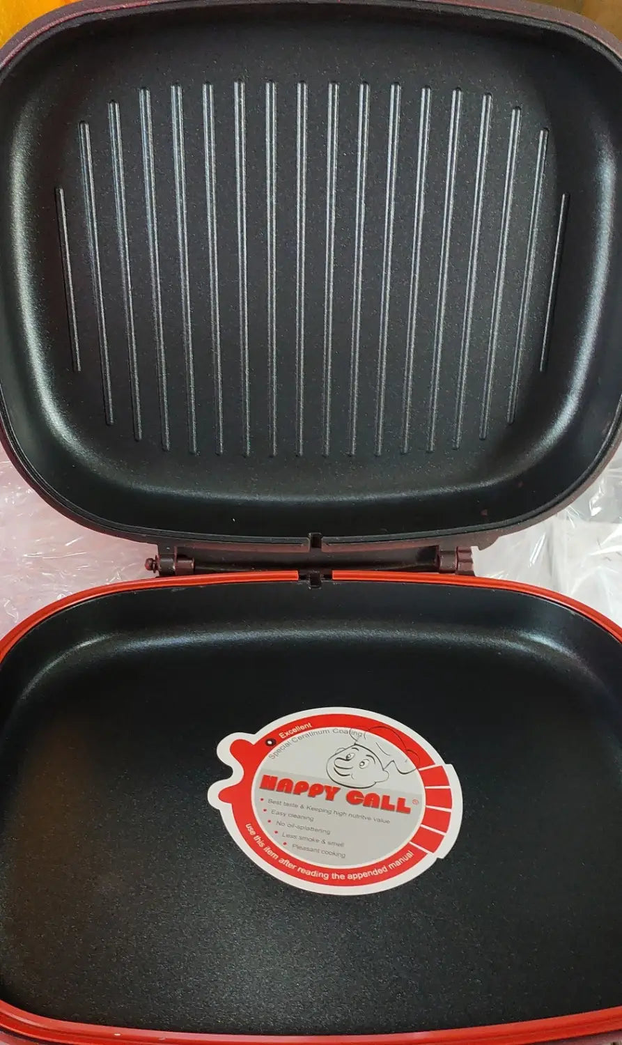 Black and orange Happycall 32cm non stick double sided frying pan with a lid featuring the brand sticker.