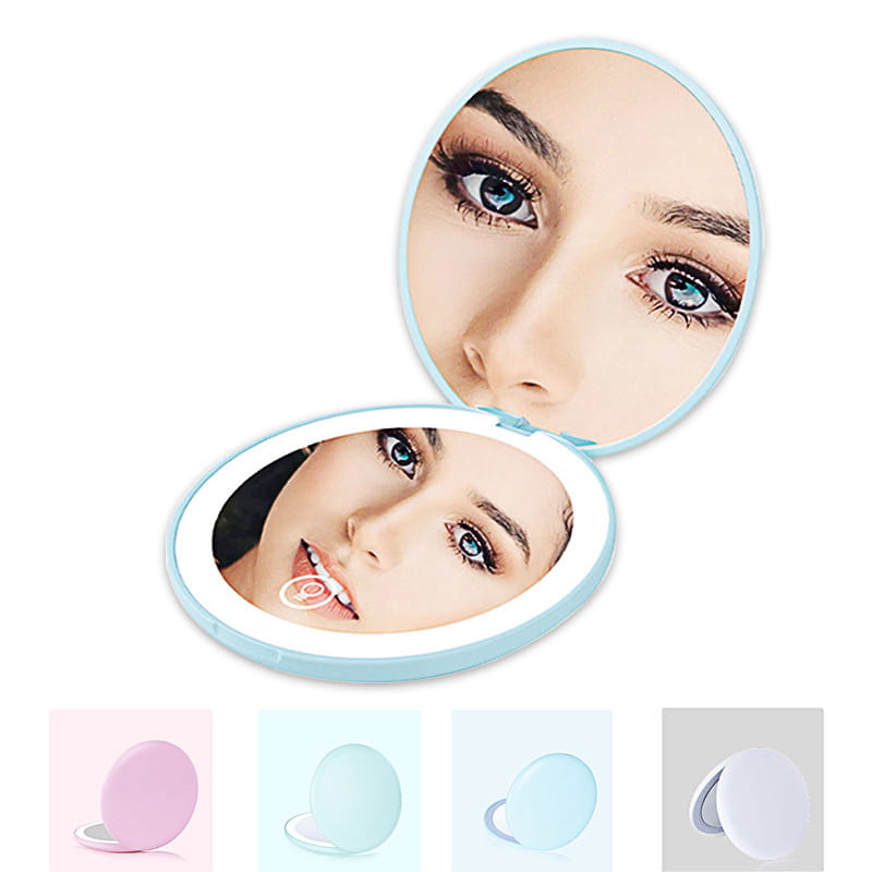 Light blue oval-shaped led makeup mirror with 10x magnification and a glowing led ring around the edge for portable use.