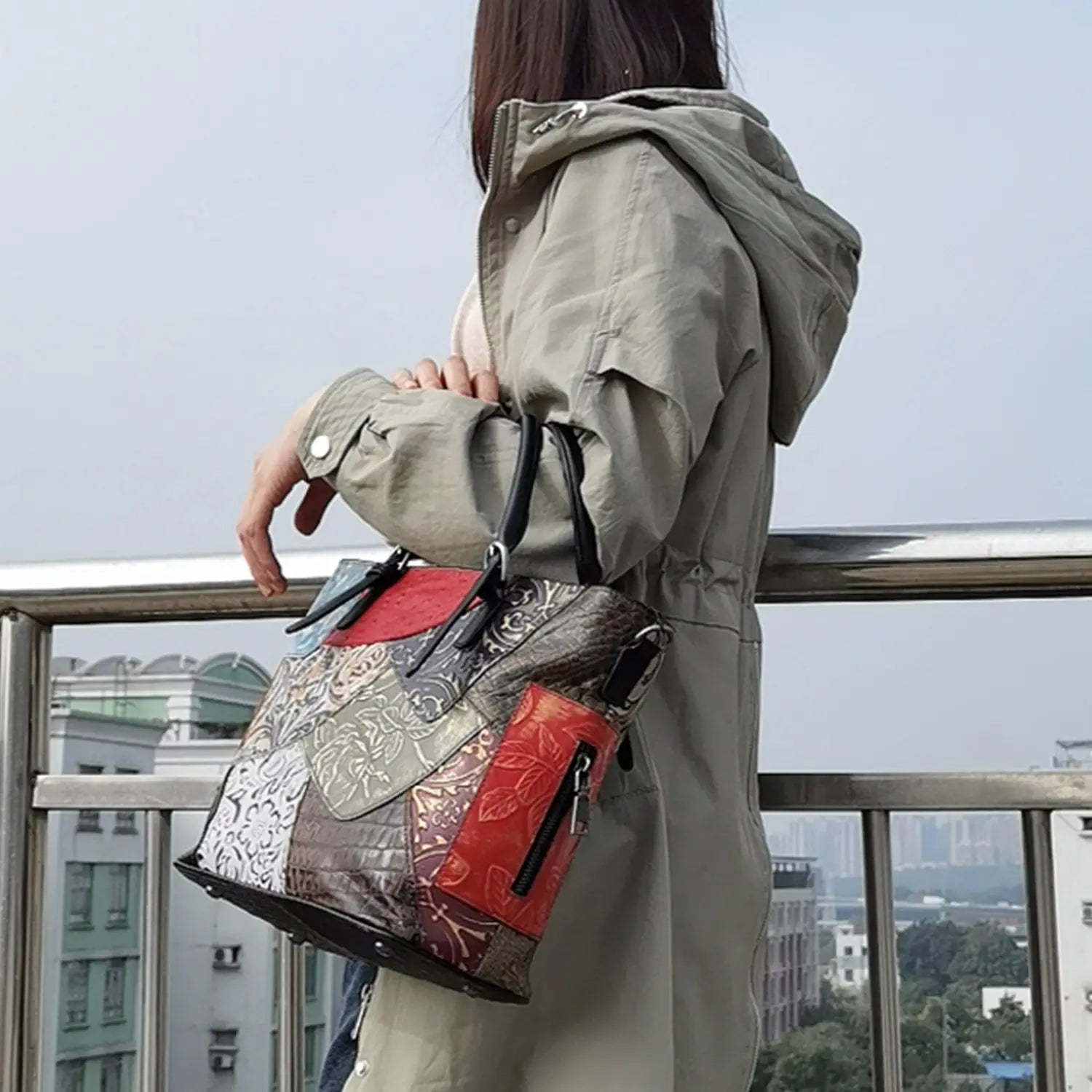 Patchwork leather women’s messenger shoulder bag featuring red silver and brown floral-patterned panels.