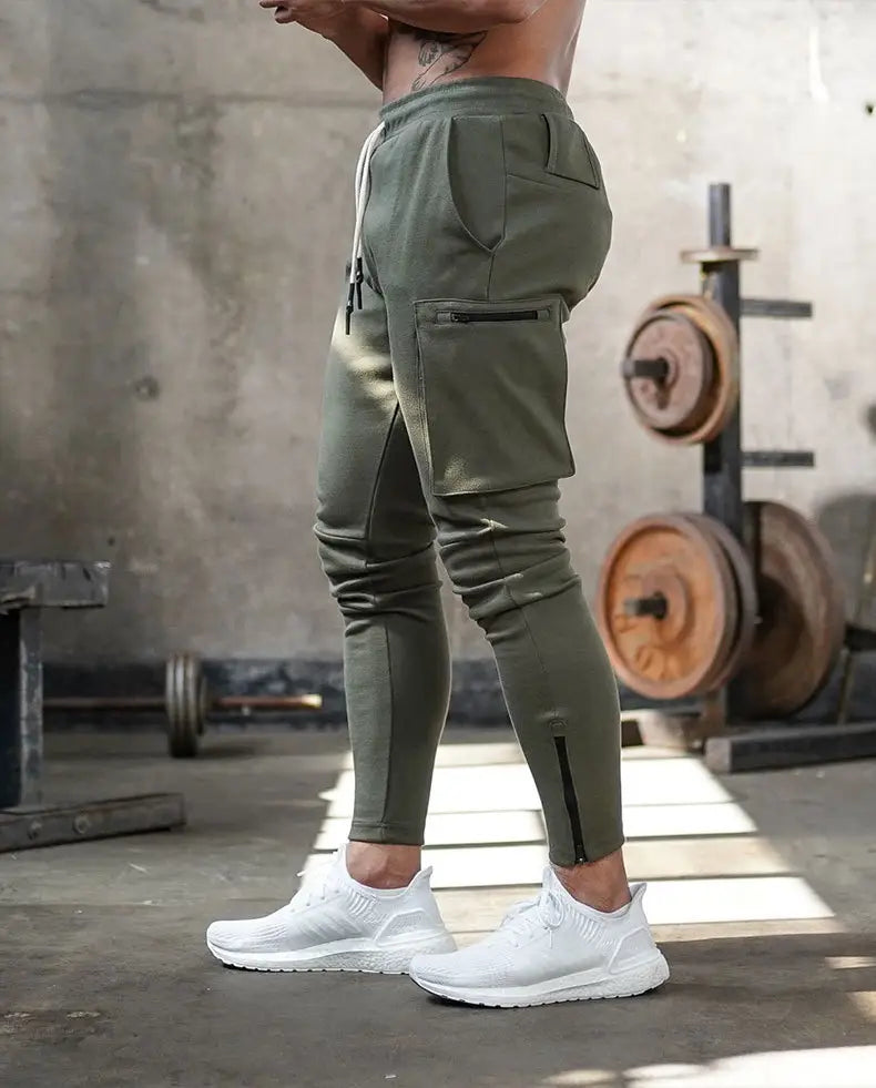 men’s olive green cargo joggers with zippered pockets and a drawstring waistband designed for fitness use