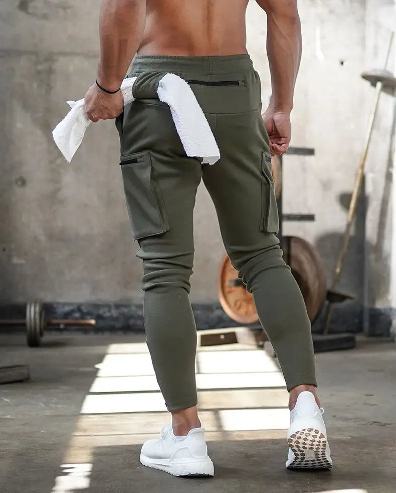 men’s olive green zipper cargo joggers with multiple pockets and a drawstring waistband designed for fitness and casual wear