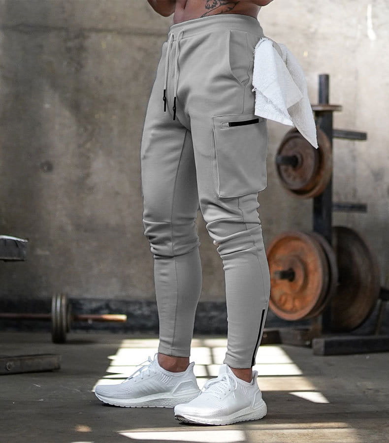 Men’s gray slim fit athletic joggers with cargo pockets and black drawstrings designed for fitness use