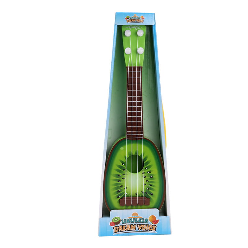 青い箱に「ukulele dream voice」と表示された、光沢のあるプラスチックボディと木製風のフレットボードを備えた、鮮やかな緑色のキウイ形の子ども用ウクレレおもちゃ。