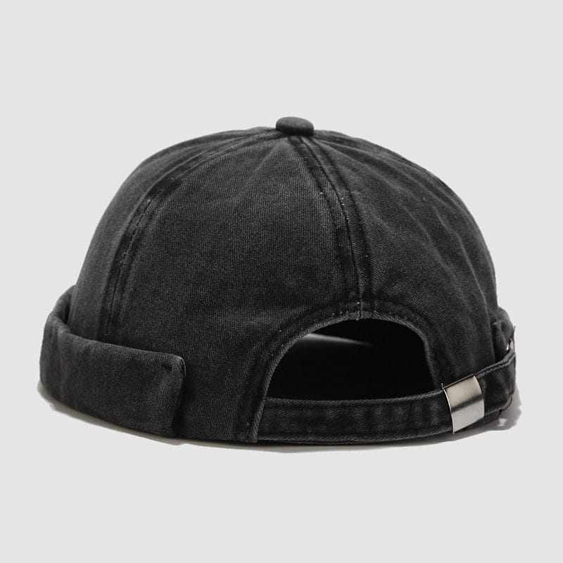 black denim baseball cap with rolled-up brim and silver metal buckle made of washed denim showcasing the back side of the retro style hat.
