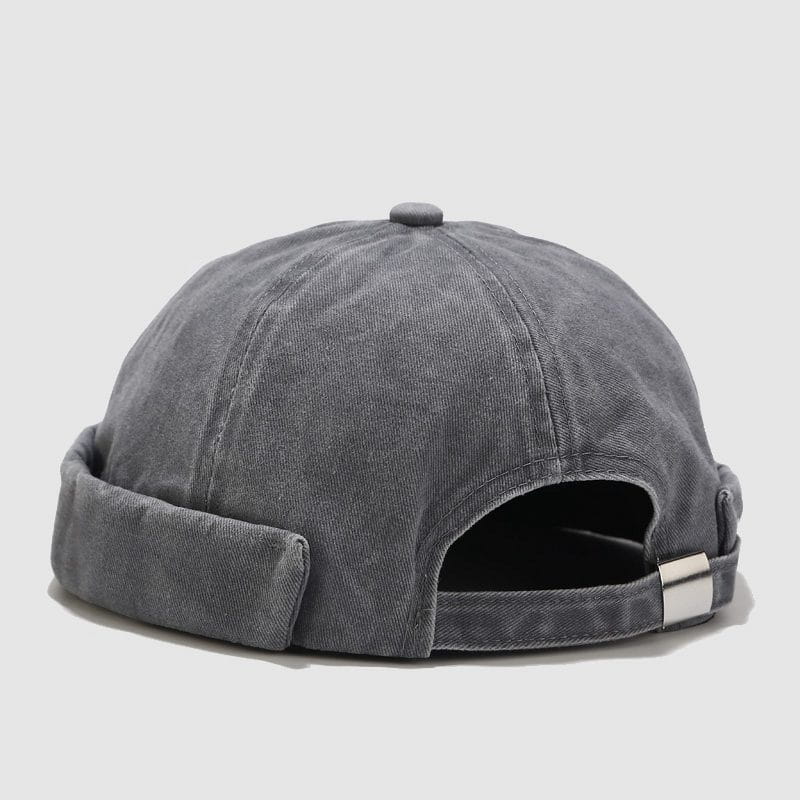 A gray washed denim baseball cap with a retro rolled brim and a silver metal buckle closure.