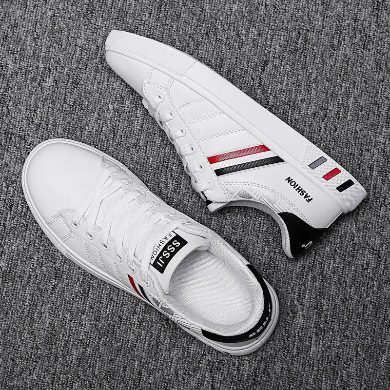 Men’s leather low top sport fashion sneakers in white featuring red and black stripes and a sleek design with branded text.