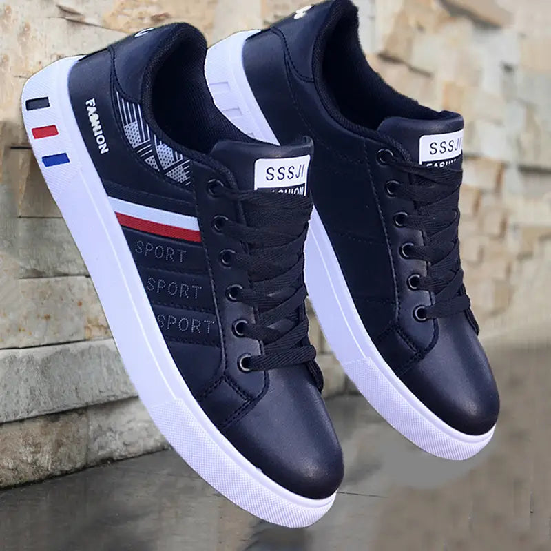 Men’s leather low top sport fashion sneakers in black and white with red blue and gray accents featuring sport text on the side.